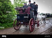 an-old-coach-and-four-with-drivers-and-passengers-suitably-dressed-in-period-costume-during-a-...jpg