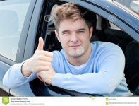 attractive-man-sitting-his-car-thumb-up-15519060.jpg